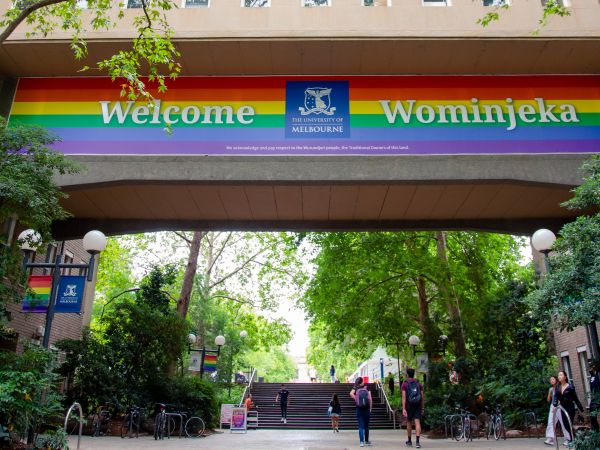 A rainbow banner hung outside at the University of Melbourne Parkville campus that reads: Welcome and Wominjeka.
