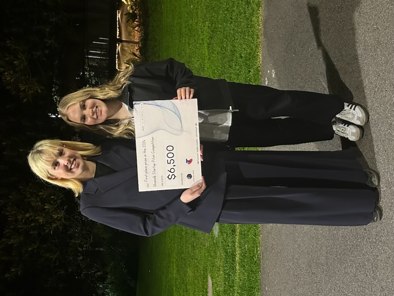 Charlotte and Lily with their cheque following their win