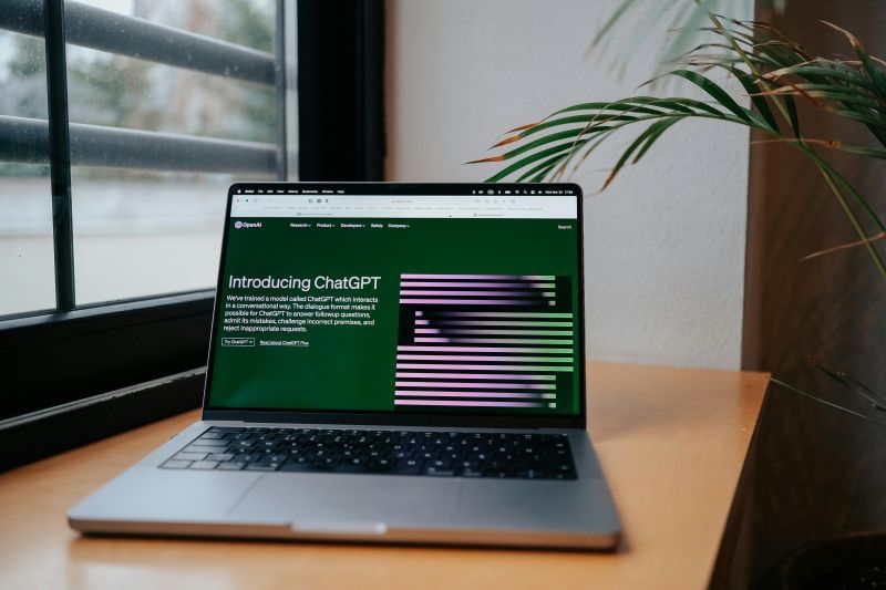 Open laptop on desk showing ChatGPT screen