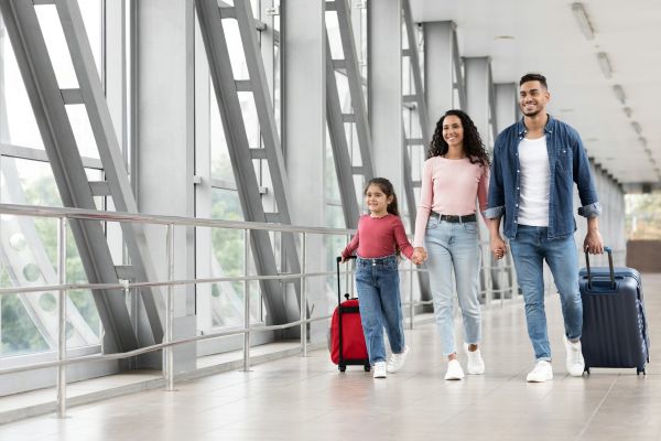 Family at airport with suitcases