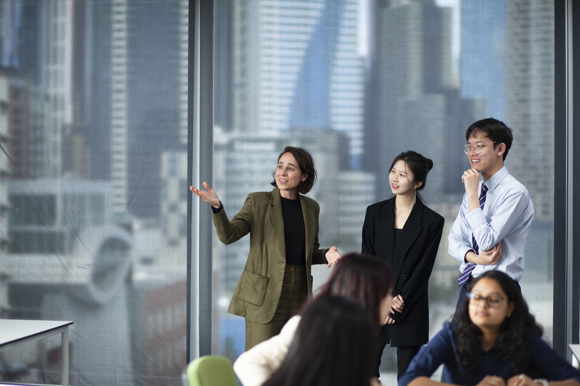 Group talking behind the backdrop of city