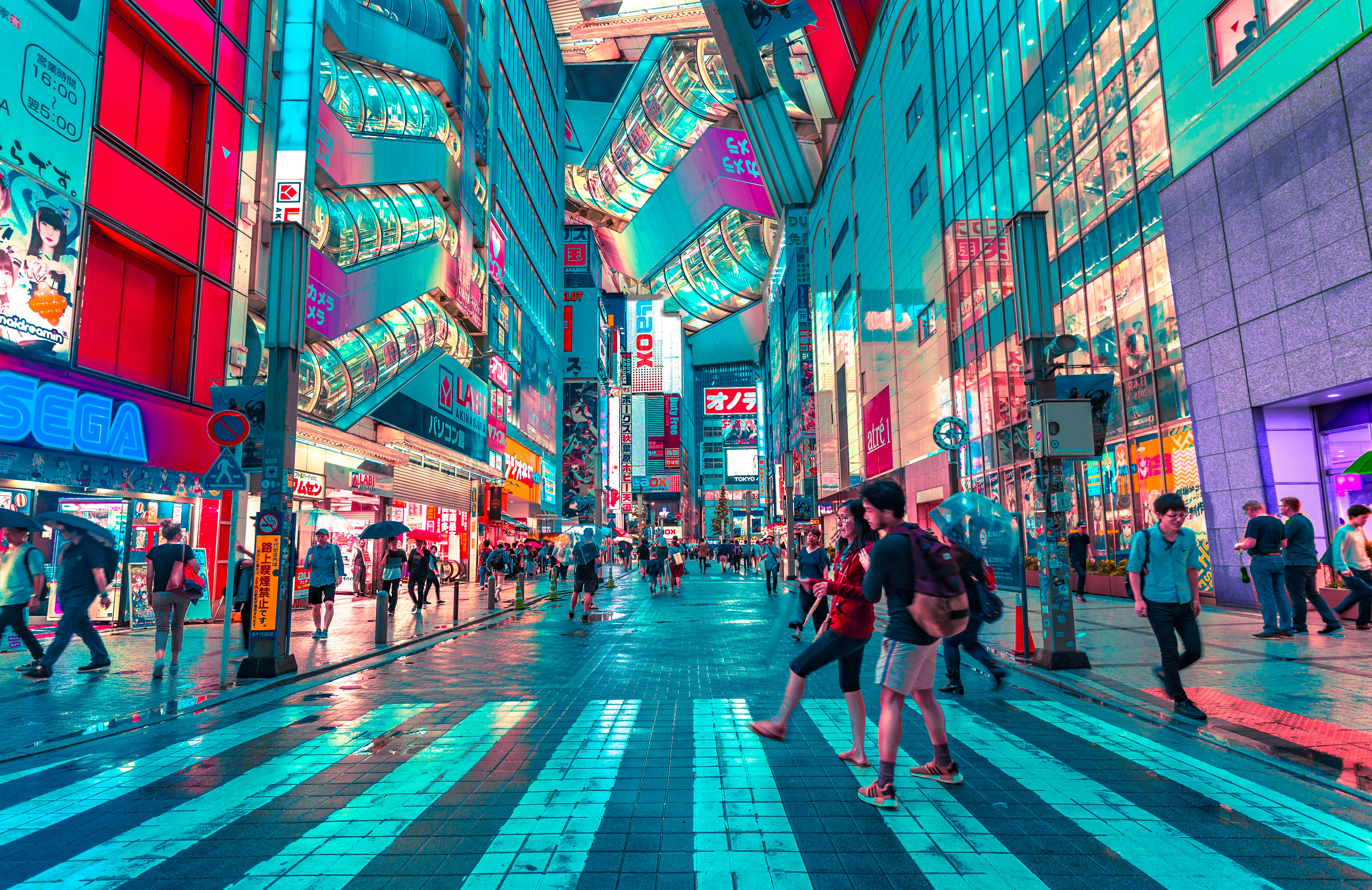 People walking on road near well-lit buildings in Tokyo, Japan
