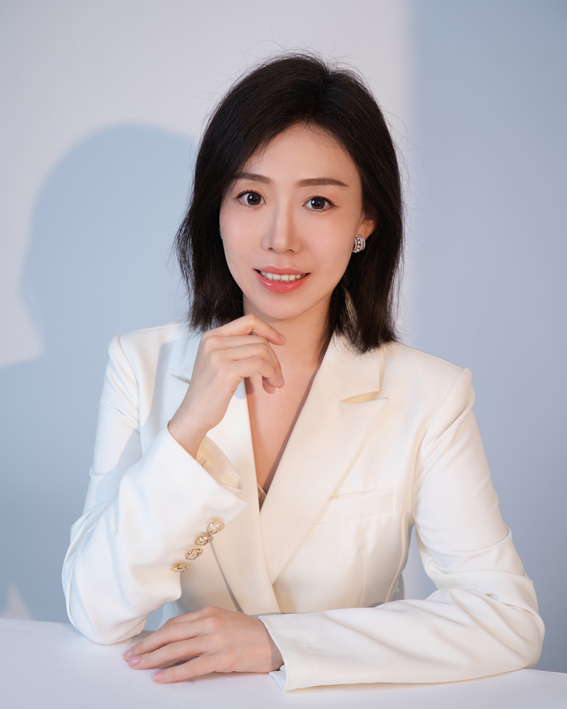 A woman wearing a white suit