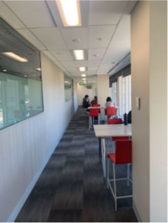 In the FBE Building Level 2, a corridor is partially obstructed by a person seated in a chair
