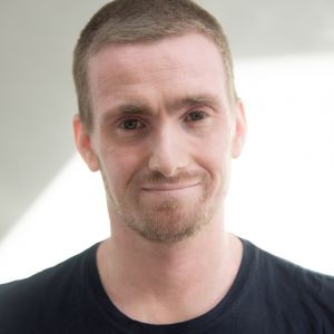 A man wearing a black top