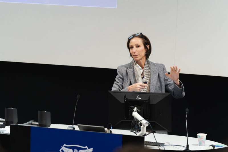 Professor Paola Conconi presenting at a lectern