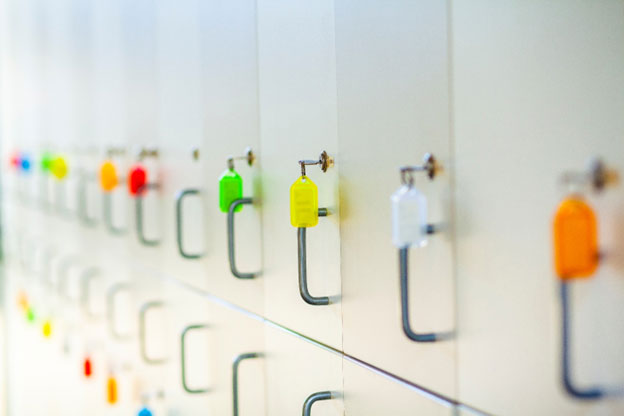 white locker doors with brightly colored keyrings in the locks 