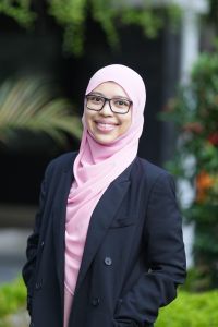 A woman wearing suit and hijab