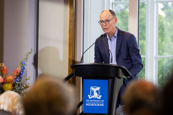 Professor Paul Kofman speaking at a lectern