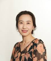 A woman wearing a flowery black top