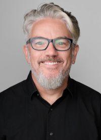 A man wearing black business shirt
