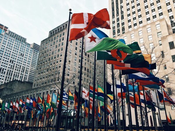 Flags on pole near building during daytime
