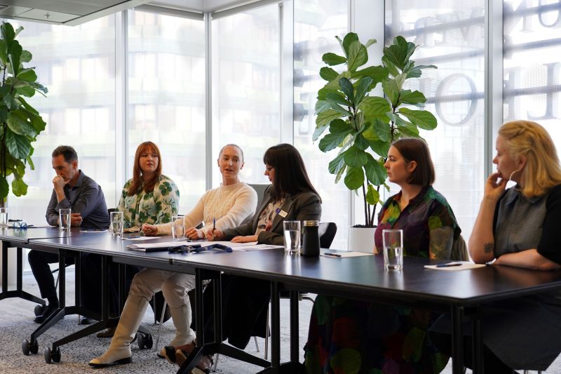 A group of people presenting as panel speakers