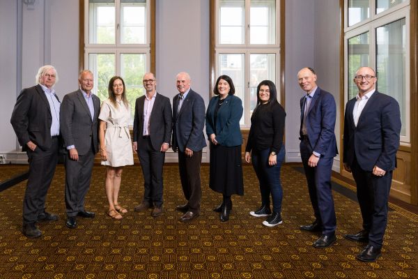 Nine people pose for a photo as a group