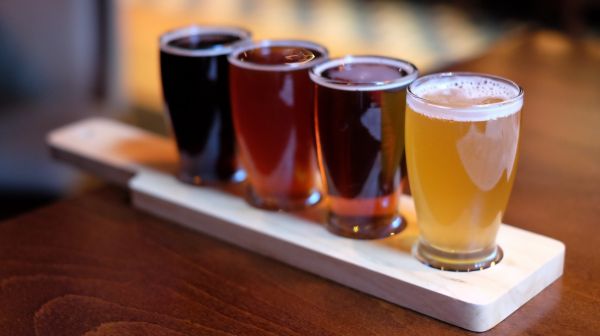 A row of drinks in a cup showing different colours
