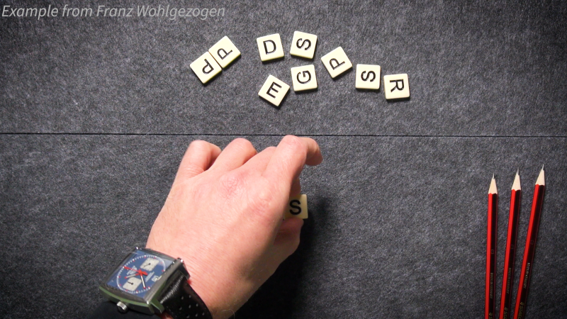 hand moving scrabble tiles