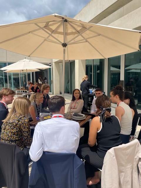 Group of students attending the Canberra briefing sat around a table