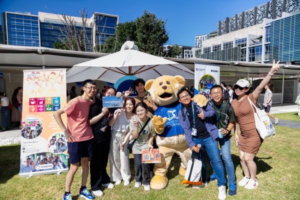 Students outside with Barry the Bear at FBE Orientation event